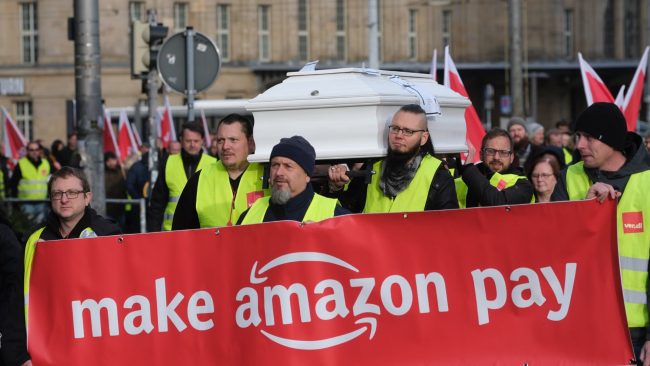 Les associations considèrent que le modèle économique d'Amazon est une aberration écologique. Ils protestent pour faire payer l'entreprise américaine. // PHOTO : Sebastian Willnow / AFP